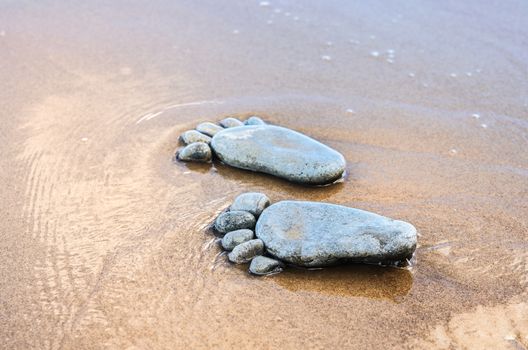 Footprints of pebbles on the sea beach