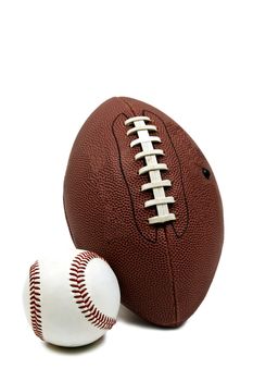 Vertical shot of American football and baseball isolated on white background