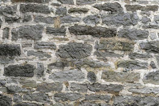 Gray patterned old worn stone wall