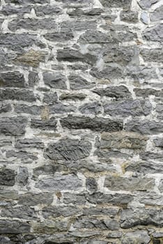 Vertical gray stone wall.  Extremely old