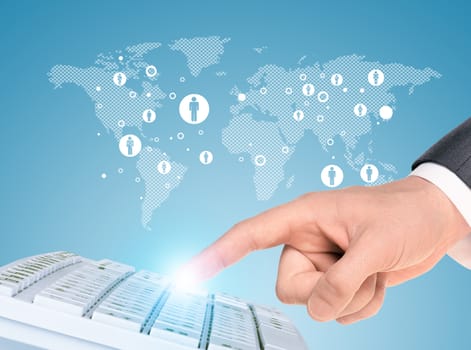 Businessmans hand touching keyboard on abstract blue background with world map and icons