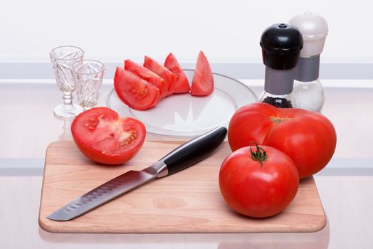 Tomatoes are sliced and salted also by pepper