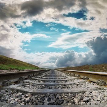 railroad to horizon in dramatic clouds