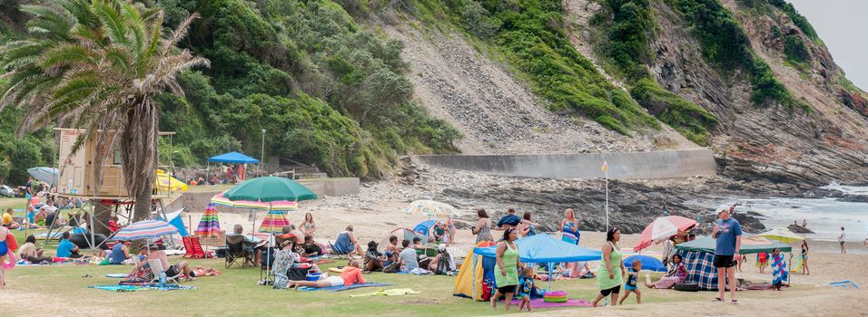 GEORGE, SOUTH AFRICA - JANUARY 4, 2015: Panorama of unidentified people at the beach in Victoria Bay at low tide