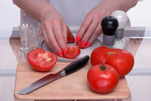 Tomatoes are sliced and salted also by pepper