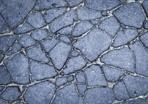 abstract background or texture asphalt pavement cracks broken