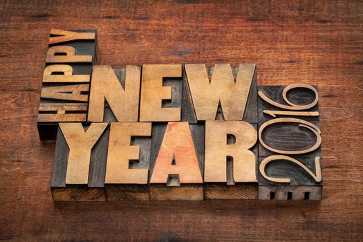 Happy New Year 2016 greetings  - word abstract in vintage letterpress wood type blocks on a grunge wooden background
