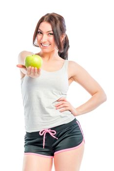 beautiful athlete holds a green apple