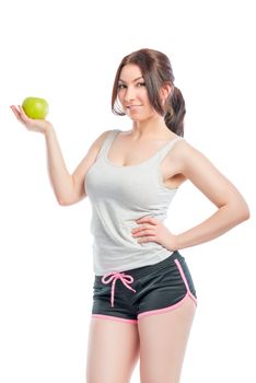 attractive girl in the sports form with green apple