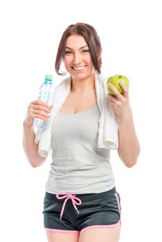 portrait of athlete with an apple and a bottle of water