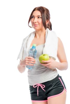 beautiful thoughtful girl holding an apple and a bottle of water