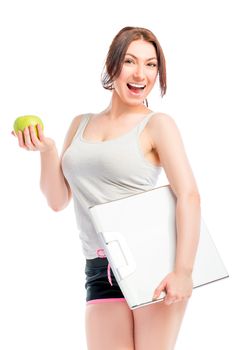 Portrait of slim girl with scales and apple