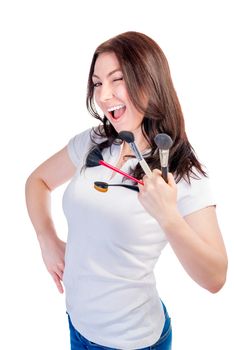 cheerful girl with brushes for make-up winks