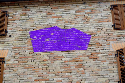 Blue sundial on a house wall