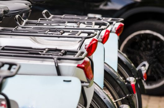 Rental bikes at a bike rental. View bicycles from behind.
