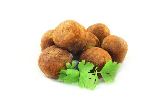 Falafel with fresh parsley on a light background