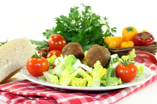 Falafel with fresh salad on a light background

