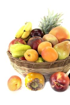 Fruit basket with various fruits on a light background