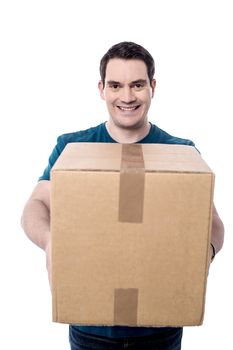 Happy casual man giving a big cardboard box
