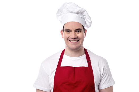 Smiling male chef posing to camera over white