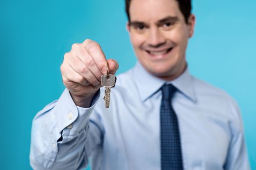 Happy real estate agent offering new house key