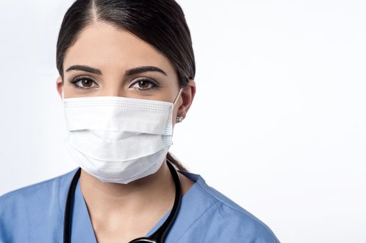 Female surgeon posing with surgical mask