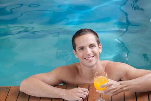 Man drinking juice inside the pool