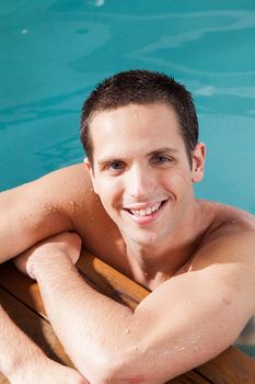 Happy man rest in the edge of the pool