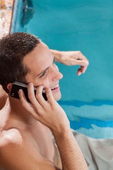 Man talking on mobile inside the pool