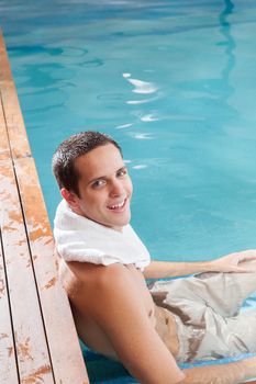 Happy guy relax inside the pool