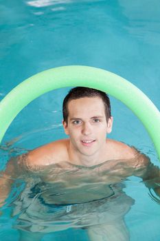 Happy man playing in the pool