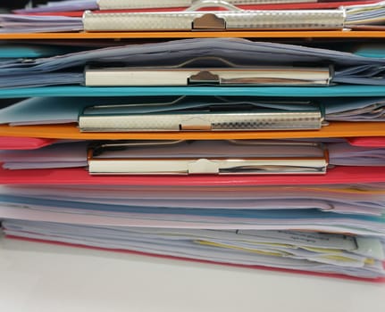 Stack of many color clipboard with document  on desk at office.                               