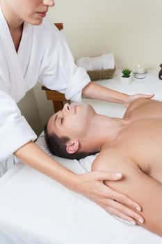 Guy laid receiving massage