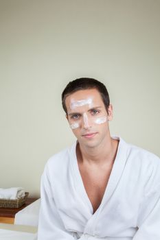 Serious guy with cream on her face