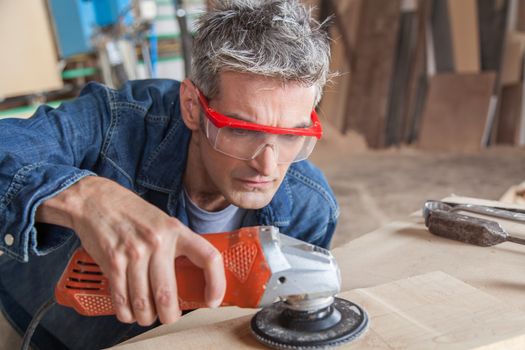 Carpenter with a sander