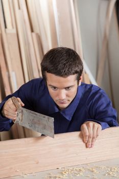 Man cutting a plank