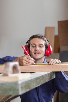 Carpenter measuring a plank