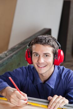 Happy carpenter in his workshop
