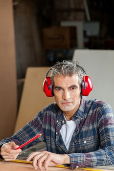Serious carpenter with headphones