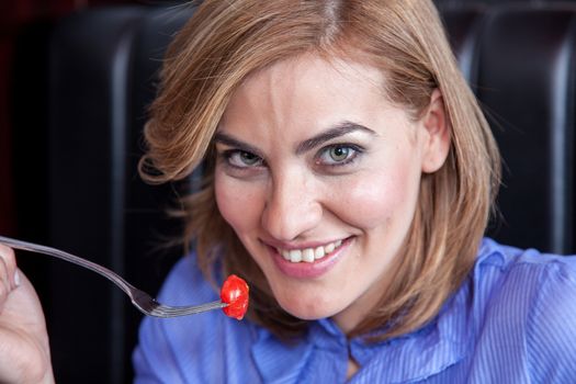 Woman is eating cherry