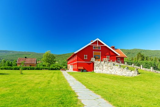 Red wooden house with orange door, barn