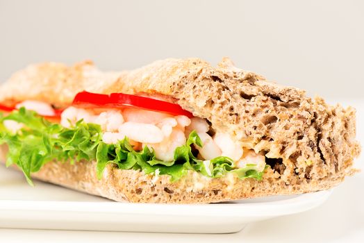 Prawn sandwich on white plate. Studio shot