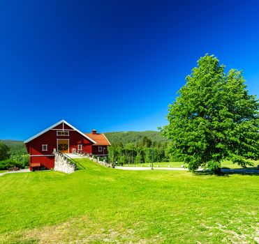 Red wooden house with orange door, barn