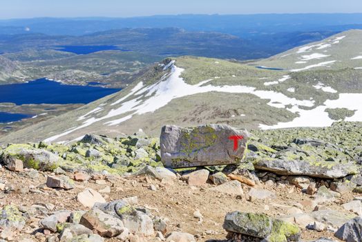 Signs of the Norwegian Trekking Association (Den norske turistforening, DNT) on the path to Gaustatoppen mountain (Norway)