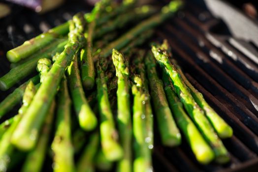 Asparagus on grill at sunset, candid picture
