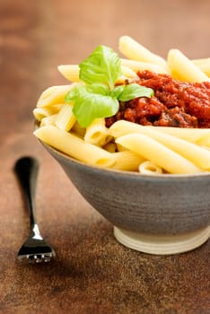 Penne pasta with a tomato bolognese beef sauce on the table