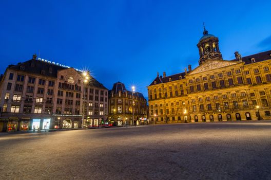 Amsterdam, Netherlands - May 7, 2015: Tourist visit Dam Square with a view of the Royal Palace and Madame Tussaud wax museum in Amsterdam, Netherlands. Its notable buildings and frequent events make it one of the most well-known and important locations in the city and the country.