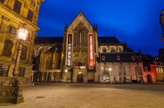 Amsterdam, Netherlands - May 7, 2015: Tourist visit Nieuwe Kerk in Dam Square, Amsterdam, Netherlands. Its notable buildings and frequent events make it one of the most well-known and important locations in the city and the country.