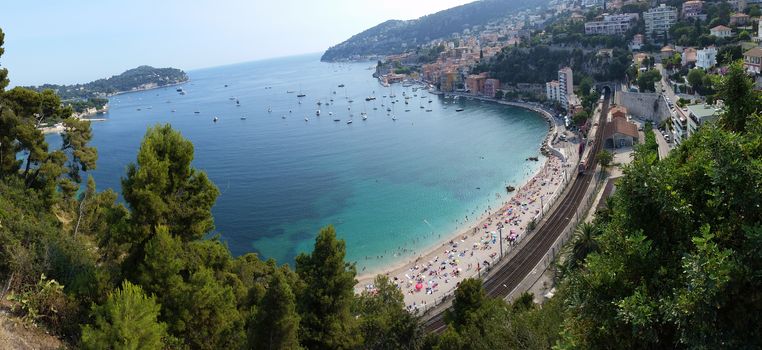 Beach with tourists in Villefranche-sur-Mer. City of the Mediterranean Sea