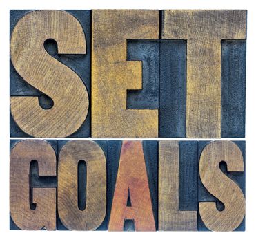 set goals typography abstract - a collage of isolated words in letterpress wood type